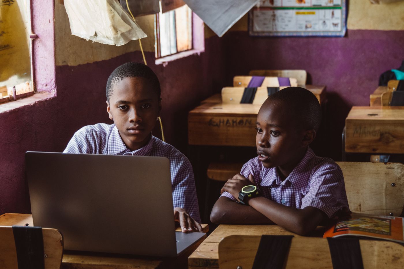 Two school pupils learning together with a laptop